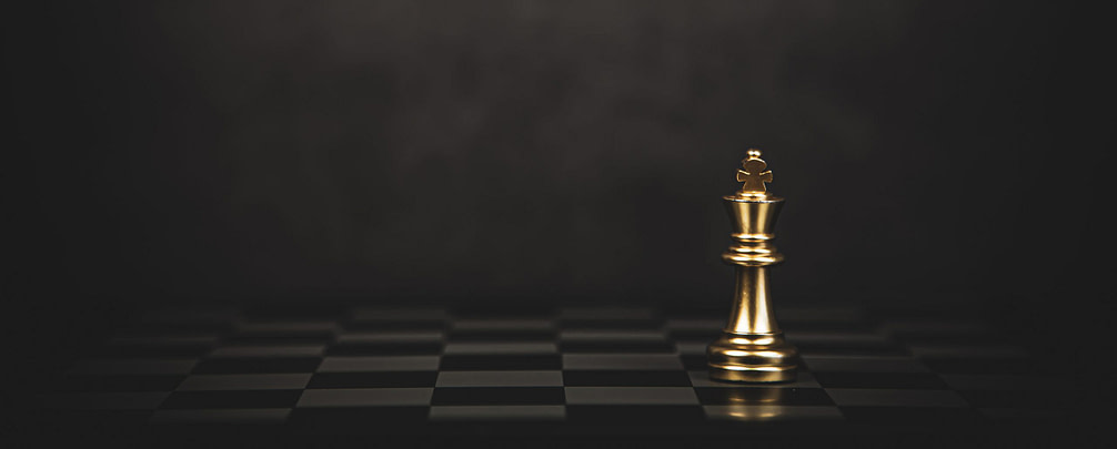 Close-up king chess standing on chess board concept of team play
