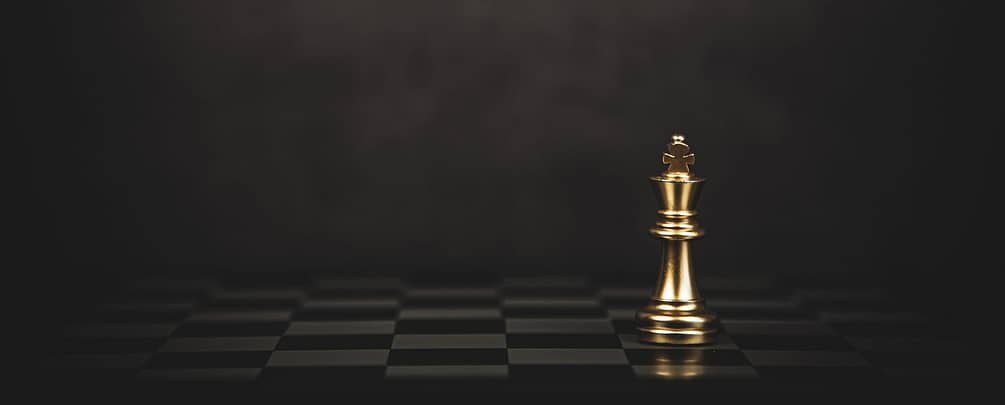 Close-up king chess standing on chess board concept of team play